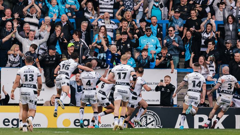 Davy Litten of Hull FC celebrates with team-mates after scoring a try.